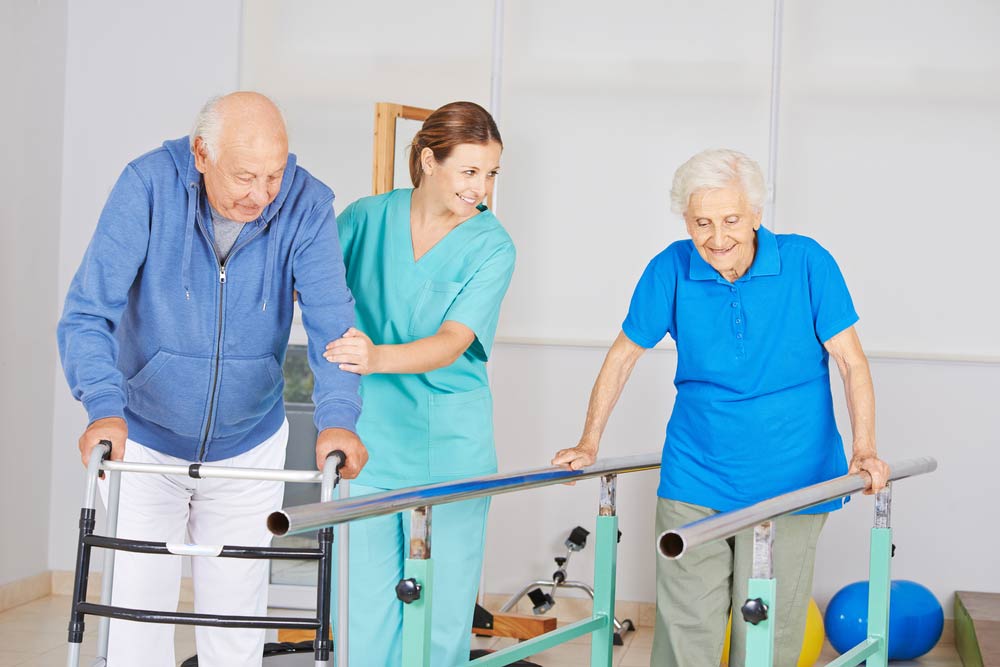 Physiotherapy with senior people on a high bar and a walker